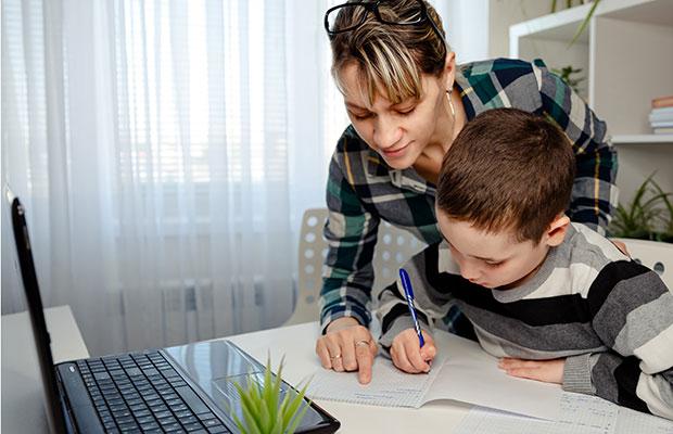 young mother and young son going over homework at home