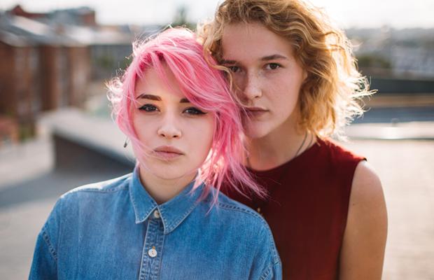 sisters, one with pink hair and dark eye makeup